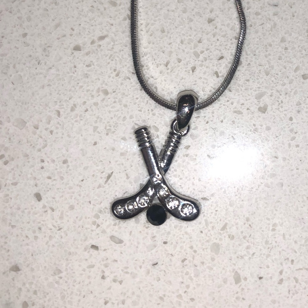 Silver hockey stick and puck necklace